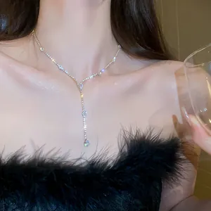 Close-up of a sparkling silver waterdrop zirconia tassel necklace on a model's neck