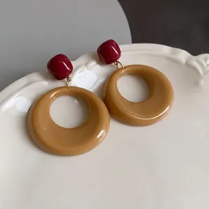 Elegant vintage Maillard style brown circular hoop earrings with deep red resin studs.