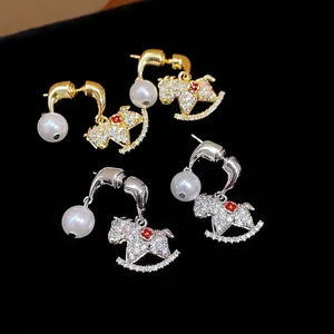 Elegant 18K gold plated rocking horse drop earrings with white pearls and sparkling crystals