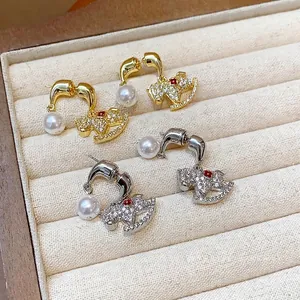 Elegant 18K gold and silver plated rocking horse earrings featuring pearls and crystals