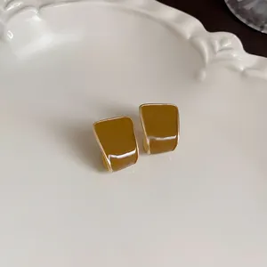 Macro detail view showing the glossy coffee enamel finish of these vintage stud earrings.