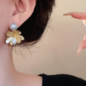 Detailed close-up of French vintage gold flower earrings featuring elegant freshwater pearls