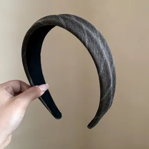 Detail showing texture of a vintage striped fabric wide-edged headband for women.