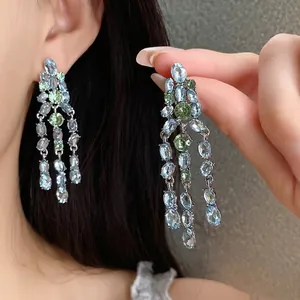 Elegant silver needle drop earrings with light blue and green oval zircon tassels.