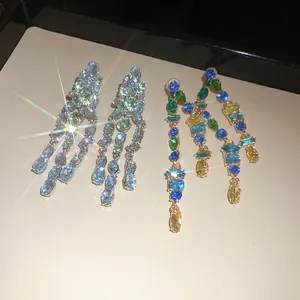 Macro detail of sparkling zirconia stones on vibrant multi-color tassel drop earrings