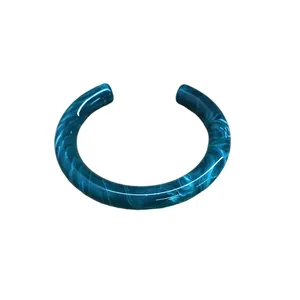 Stylish marbled acrylic open cuff bracelet with a vibrant blue teal swirl pattern.