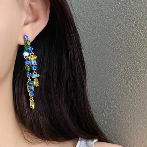 Detailed close-up showing elegant multi-color zircon tassel earrings on a model's ear
