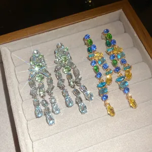 Detailed macro shot of shimmering crystal tassel earrings in a luxury tray