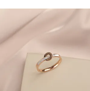 Detailed close-up of rose gold ring with white shell inlay and LOVE FOREVER engraving