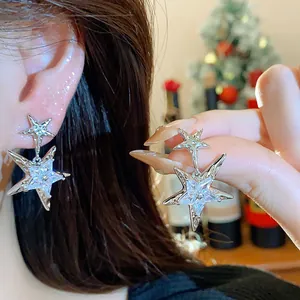 Close-up of sparkling star earrings with cubic zirconia and silver posts