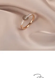 Detail view of a rose gold elegant ring with shell inlay and LOVE FOREVER engraved logo