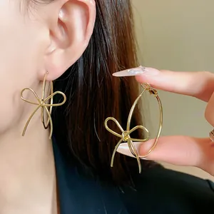 Elegant gold-tone bow hoop earrings with silver needle for women's fashion jewelry