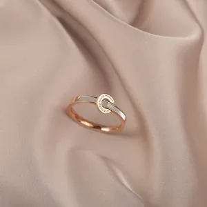 Close-up of elegant rose gold ring with white shell inlay and Love Forever engraving