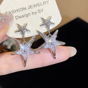 Detail view of sterling silver star earrings inlaid with sparkling cubic zirconia stones