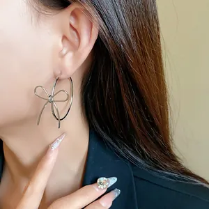 Elegant silver bow hoop earrings for women featuring a minimalist and niche design