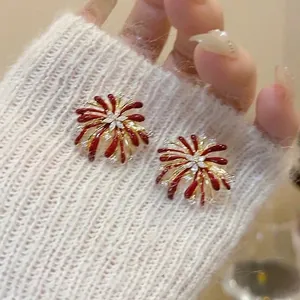 Elegant red firework earrings with crystal accents in a festive gold finish