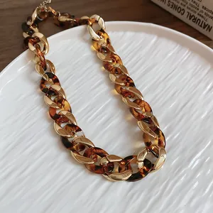 Bold chunky chain necklace featuring alternating gold-tone and tortoise shell acrylic links
