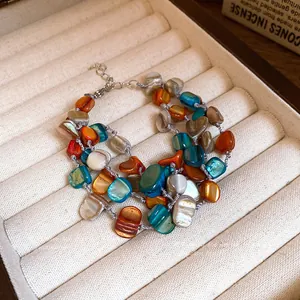 Bohemian multi-strand bracelet with irregular colorful shell beads in a jewelry box