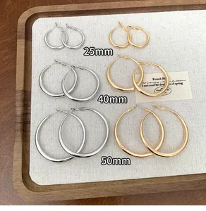 A detailed comparison of minimalist hoop earrings in 25mm, 40mm, and 50mm sizes.