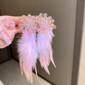 Handcrafted bohemian pink feather drop earrings with elegant sparkling crystal accents