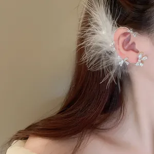 Exquisite white feather ear cuff with sparkling crystal-encrusted bow detailing
