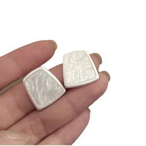 Minimalist trapezoid resin stud earrings with white marble texture and silver trim