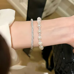 Close-up view of elegant Italian twisted mesh bracelet and pearl hand jewelry set