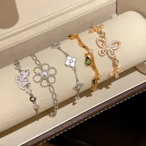 Detailaufnahme von fünf Luxus-Zirkonia-Armbändern mit Schmetterlings-, Blumen- und Kleemotiven.