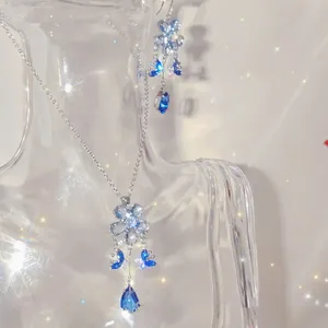 Detailed view of elegant blue zircon flower and butterfly tassel jewelry set on bust