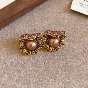Elegant vintage palace style flower pearl stud earrings with sparkling rhinestones.