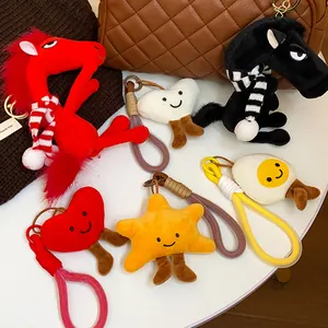 Collection of cute plush keychains including grumpy horses, hearts, star, and fried egg.