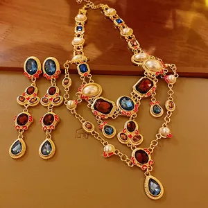 Macro view of vintage pearl necklace set with blue and red crystal water drop details
