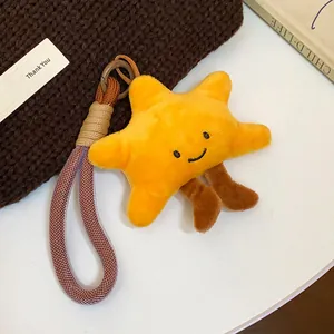 Close-up of yellow plush star pendant with cute smile and woven rope loop