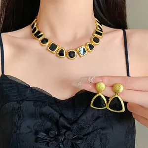 Elegant vintage gold-toned geometric necklace and earrings set with black enamel inlay