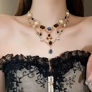 Detailed close-up of a vintage multi-layered necklace with pearls and blue teardrop gems