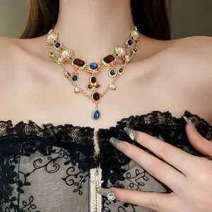 Close-up detail of a luxury vintage rhinestone pearl teardrop necklace worn by a model