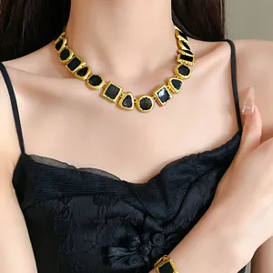 Vintage geometric patchwork necklace with gold-tone frame and black enamel inserts