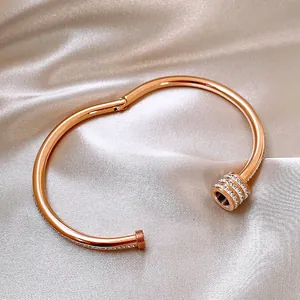Rose gold plated titanium steel bangle with sparkling crystals on champagne satin