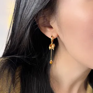Elegant vintage gold-toned hoop earrings with tiger eye stone tassels and dainty pearls