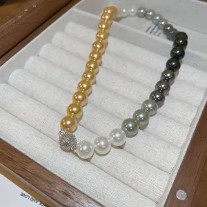 Detailed close-up of a French vintage multi-colored pearl beaded necklace in a jewelry box