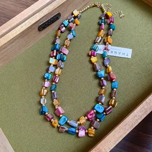 Macro view of vintage Bohemian double-layer necklace with colorful irregular shell beads