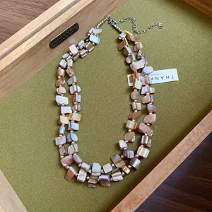 Close-up of bohemian double-layer necklace featuring irregular natural shell pieces