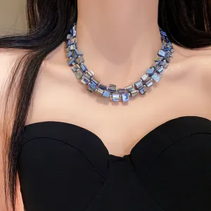 Close-up of bohemian blue iridescent double-layer shell necklace on a model neck.