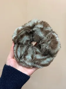 Plush faux fur scrunchie with brown striped pattern for autumn and winter hair styling