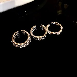 Primo piano di tre anelli aperti in stile vintage con strass brillanti e finitura argento