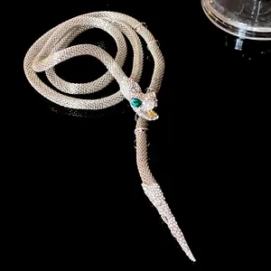 Close-up of heavy-duty rhinestone snake necklace with green gem eye