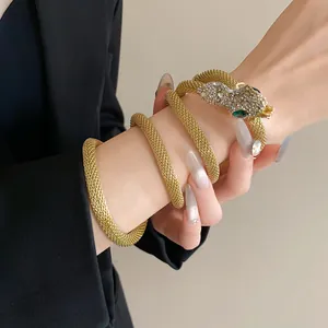 Elegant gold mesh snake-shaped necklace wrapped as a bracelet with sparkling rhinestones