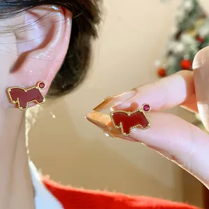 Red horse stud earrings with gold trim and zircon accent shown in a detailed view.