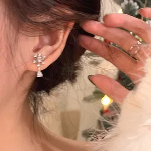 Detailed close-up showing a sparkling rhinestone snowflake earring for Christmas outfit
