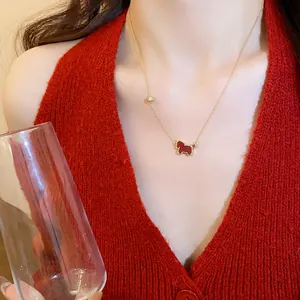 Detailed macro view of a zircon red pony pendant necklace with fine gold chain